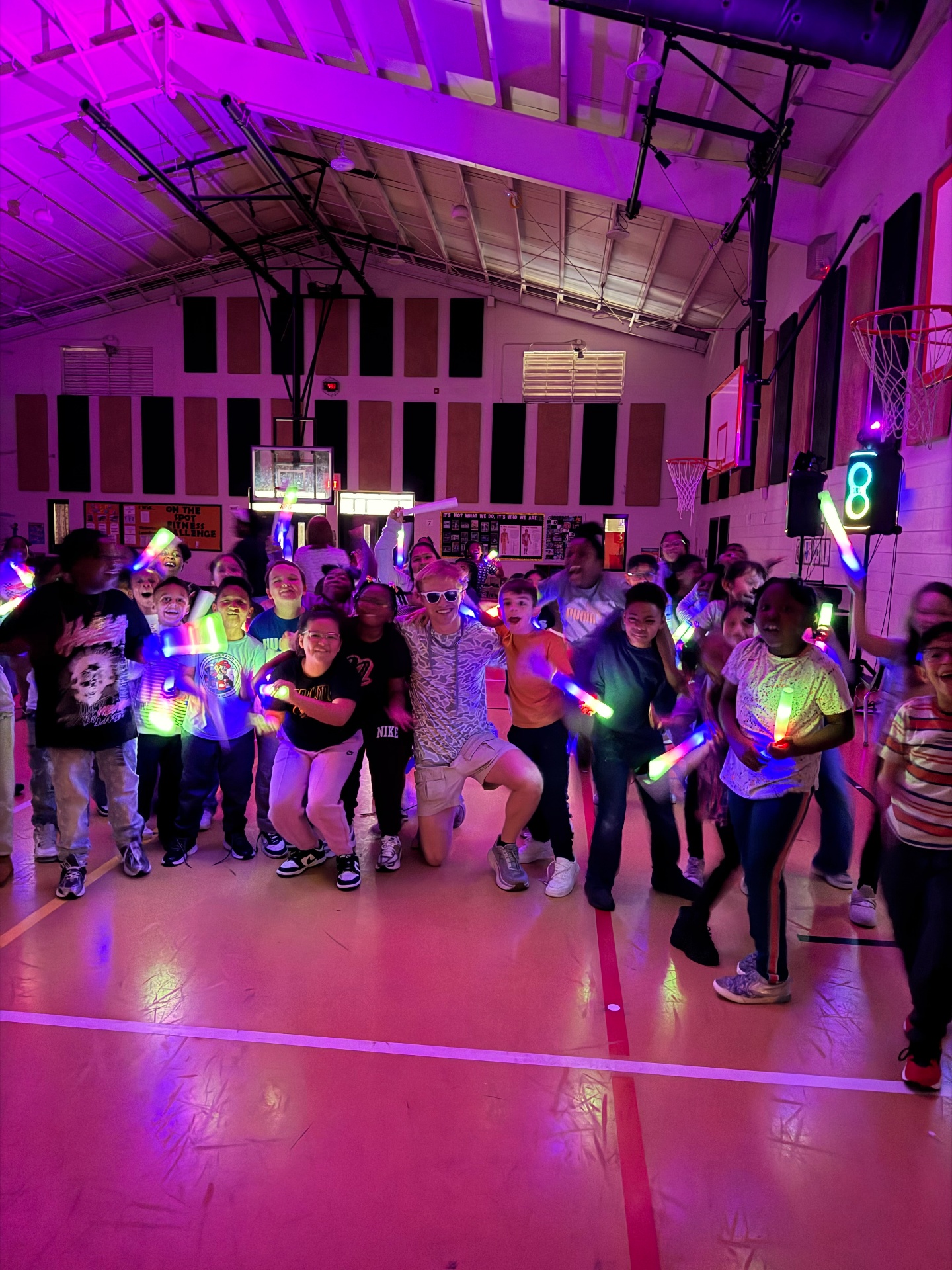 School dance with glow sticks and colorful lighting